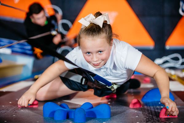 A girl ascending the Xheight climbing wall